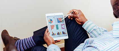 Hombre estudiando graficas financieras en su tableta